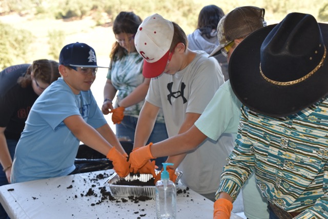 students playing with dirt